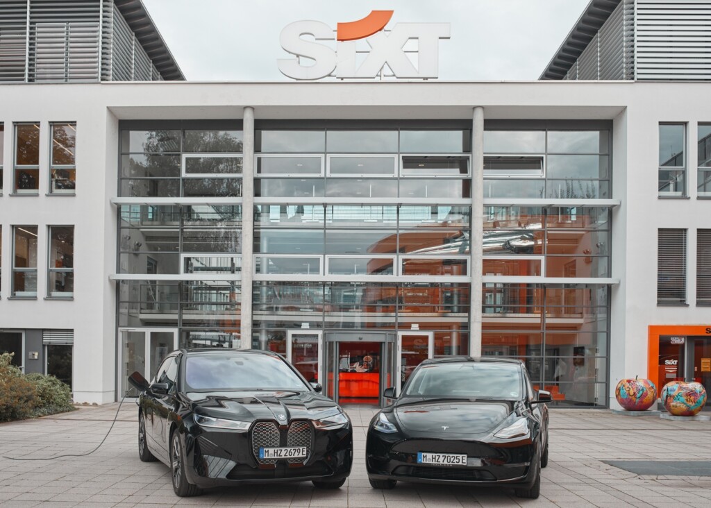 SIXT_BMWiX and Tesla Model Y in front of SIXT Headquarters in Pullach_landscape