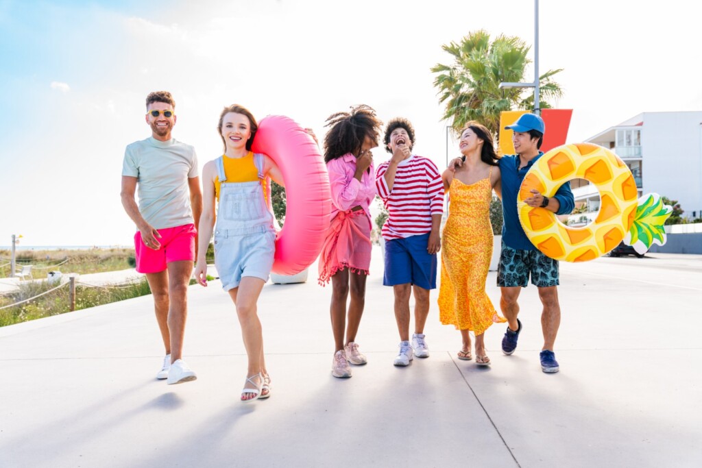 Multiethnic group of young happy friends bonding outside, having fun on summertime vacation - Multicultural cheerful people with summer clothes enjoying summer holidays, concepts about youth, friendship and positive emotion